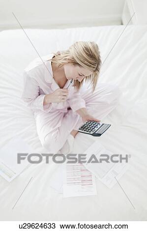 Woman working on bed View Large Photo Image Stock Image - Woman working on bed. Fotosearch