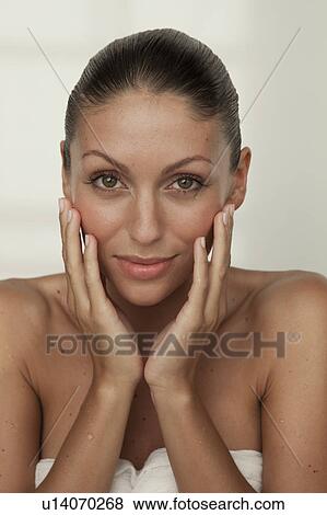 Stock Photo - Woman's hands cupping her face. Fotosearch