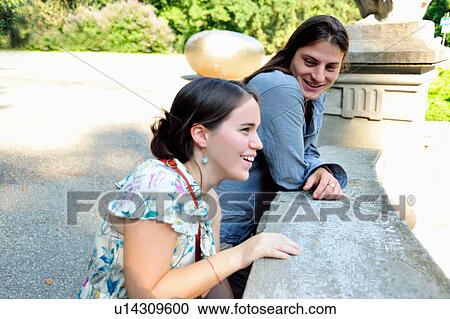 Women leaning on stone banister View Large Photo Image Stock Image - Women leaning on stone banister. Fotosearch