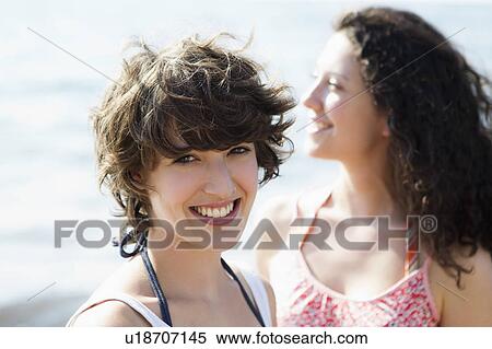 Stock Photography - Women smiling together outdoors. Fotosearch