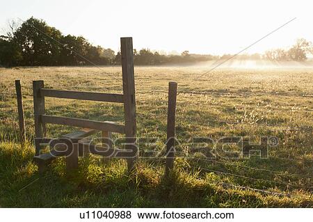 Wooden fence in grassy field View Large Photo Image Stock Photo - Wooden fence in grassy field. Fotosearch