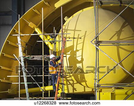 Stock Photo - Worker building ship components. Fotosearch