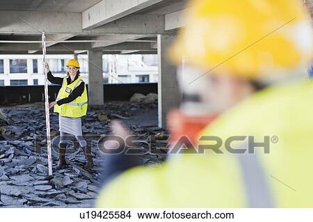 Worker measuring space on site View Large Photo Image Picture - Worker measuring space on site. Fotosearch