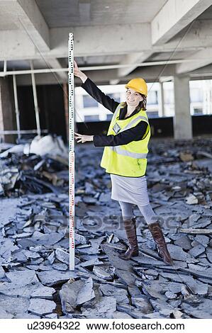 Worker measuring space on site View Large Photo Image Stock Image - Worker measuring space on site. Fotosearch