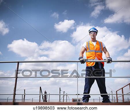 Worker standing on ship View Large Photo Image Stock Image - Worker standing on ship. Fotosearch
