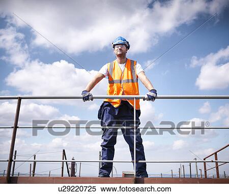 Stock Photography - Worker standing on ship. Fotosearch