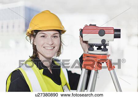 Stock Image - Worker using equipment on site. Fotosearch