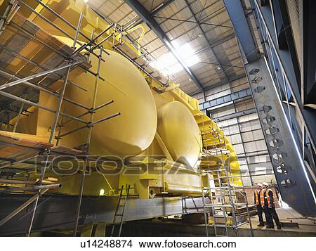 Workers examining ship components View Large Photo Image Picture - Workers examining ship components. Fotosearch