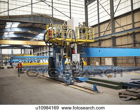 Workers examining shipbuilding machinery View Large Photo Image Stock Photo - Workers examining shipbuilding machinery. Fotosearch