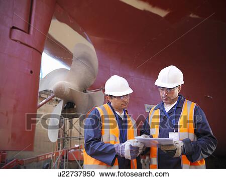 Workers talking on shipbuilding site View Large Photo Image Stock Image - Workers talking on shipbuilding site. Fotosearch