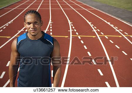 Athlete standing on track View Large Photo Image Stock Photo - Athlete standing on track. Fotosearch