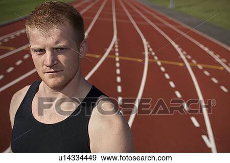 Stock Photo - Athlete standing on track. Fotosearch