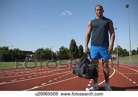 Athlete standing on track View Large Photo Image Stock Photo - Athlete standing on track. Fotosearch