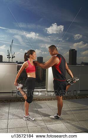 Athletes exercising together on rooftop View Large Photo Image Picture - Athletes exercising together on rooftop. Fotosearch