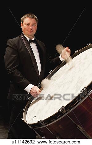 Stock Image - Bass drum player in orchestra. Fotosearch
