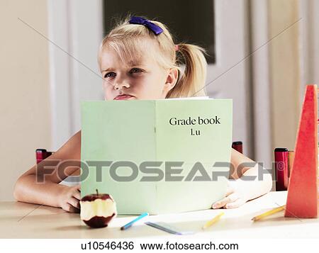 Bored girl doing homework at desk View Large Photo Image Stock Photograph - Bored girl doing homework at desk. Fotosearch