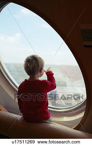 Boy admiring ocean from ship window View Large Photo Image Stock Photo - Boy admiring ocean from ship window. Fotosearch