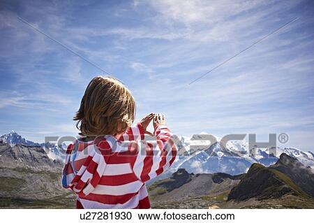 Stock Image - Boy admiring rocky landscape. Fotosearch