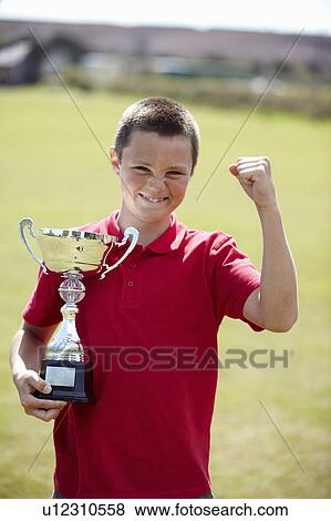 Boy cheering with trophy outdoors View Large Photo Image Stock Photo - Boy cheering with trophy outdoors. Fotosearch