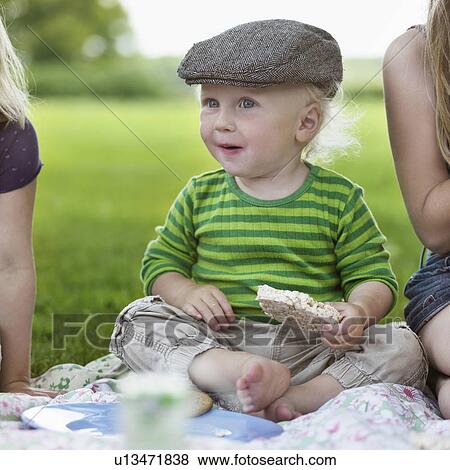 Boy eating rice cake at picnic View Large Photo Image Stock Photo - Boy eating rice cake at picnic. Fotosearch