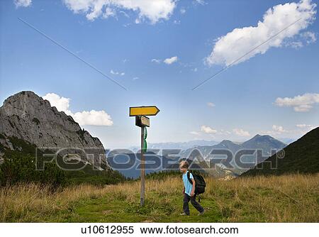 Boy hiking on grassy terrain View Large Photo Image Stock Photography - Boy hiking on grassy terrain. Fotosearch