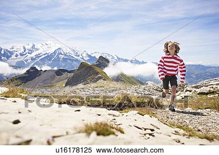 Boy running in rocky landscape View Large Photo Image Stock Photography - Boy running in rocky landscape. Fotosearch