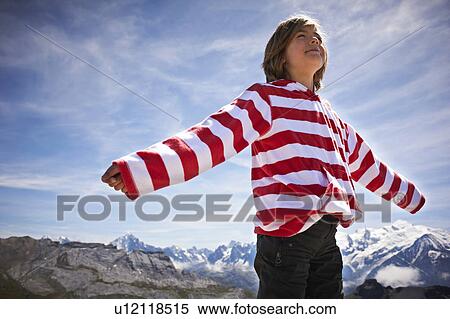 Boy standing in rocky landscape View Large Photo Image Stock Photography - Boy standing in rocky landscape. Fotosearch