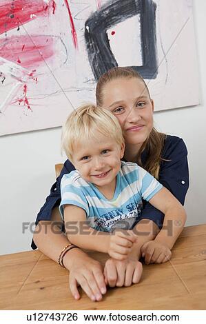 Brother and sister at table View Large Photo Image Stock Photograph - Brother and sister at table. Fotosearch