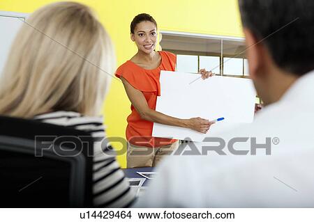 Picture - Businesswoman holding blank card. Fotosearch