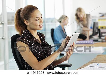 Businesswoman using digital tablet View Large Photo Image Stock Photo - Businesswoman using digital tablet. Fotosearch