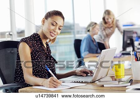 Businesswoman using laptop in office View Large Photo Image Stock Image - Businesswoman using laptop in office. Fotosearch