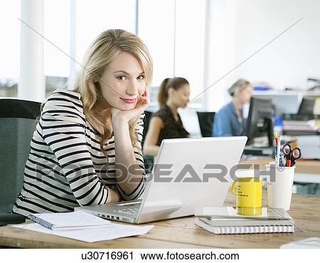 Businesswoman using laptop in office View Large Photo Image Stock Image - Businesswoman using laptop in office. Fotosearch