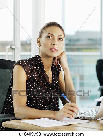 Businesswoman using laptop in office View Large Photo Image Stock Photo - Businesswoman using laptop in office. Fotosearch