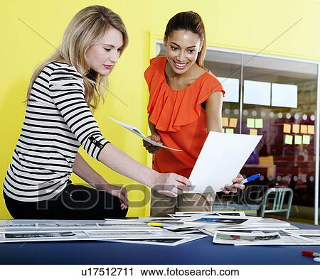 Businesswomen talking in office View Large Photo Image Stock Image - Businesswomen talking in office. Fotosearch