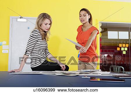 Businesswomen talking in office View Large Photo Image Stock Photo - Businesswomen talking in office. Fotosearch