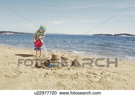 Child making moat around sandcastle View Large Photo Image Stock Image - Child making moat around sandcastle. Fotosearch