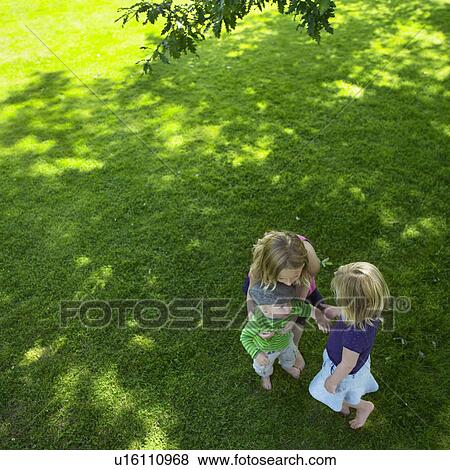 Children playing in field View Large Photo Image Stock Photo - Children playing in field. Fotosearch