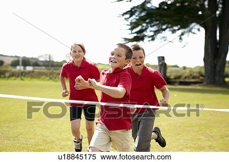 Children racing to cross finish line View Large Photo Image Stock Photography - Children racing to cross finish line. Fotosearch