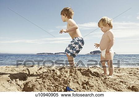 Children stomping on sandcastle View Large Photo Image Stock Photography - Children stomping on sandcastle. Fotosearch