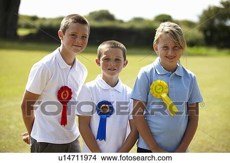 Children wearing ribbons in field View Large Photo Image Picture - Children wearing ribbons in field. Fotosearch