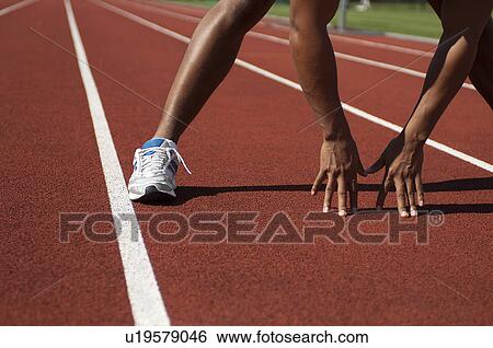 Stock Photograph - Close up of athlete in start position. Fotosearch