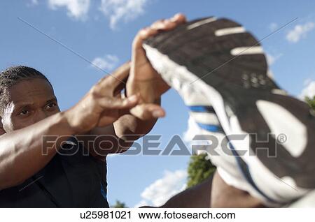 Close up of athlete stretching outdoors View Large Photo Image Stock Image - Close up of athlete stretching outdoors. Fotosearch