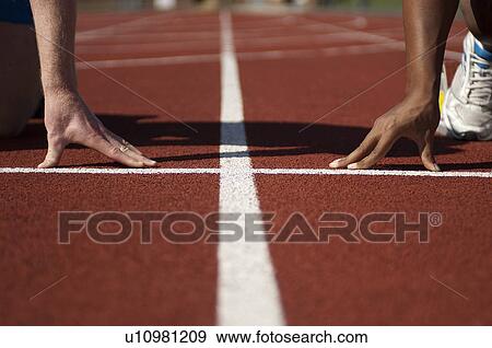 Close up of athletes' hands on track View Large Photo Image Stock Photo - Close up of athletes' hands on track. Fotosearch