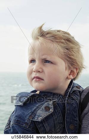 Picture - Close up of boy's serious face. Fotosearch