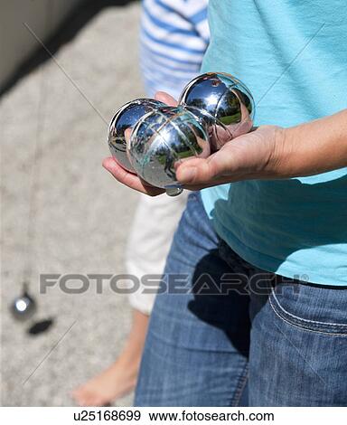 Close up of child holding silver balls View Large Photo Image Stock Photo - Close up of child holding silver balls . Fotosearch