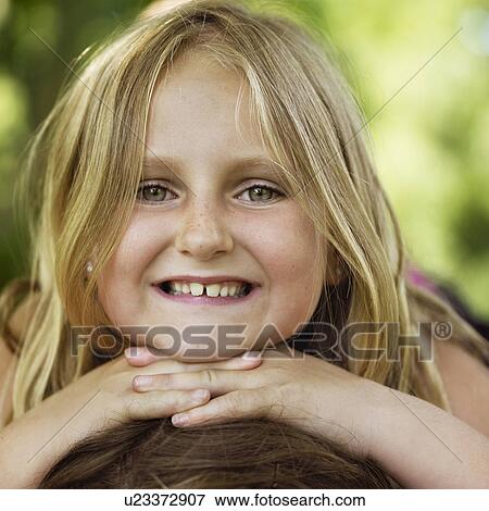 Close up of girl's smiling face View Large Photo Image Stock Photo - Close up of girl's smiling face. Fotosearch