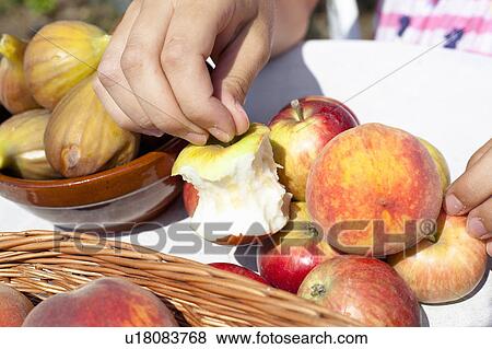 Stock Photo - Close up of half-eaten apple on table. Fotosearch