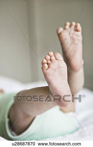 Stock Image - Close up of infant's feet. Fotosearch