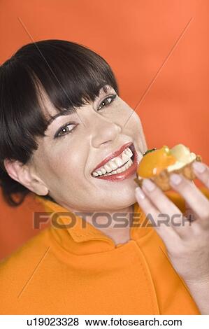 Close up of woman eating snack View Large Photo Image Stock Photo - Close up of woman eating snack. Fotosearch