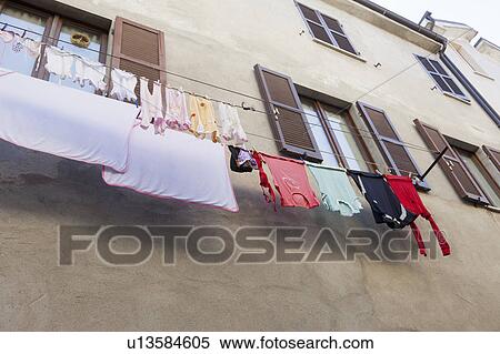Clothes hanging on line from windows View Large Photo Image Stock Photography - Clothes hanging on line from windows. Fotosearch